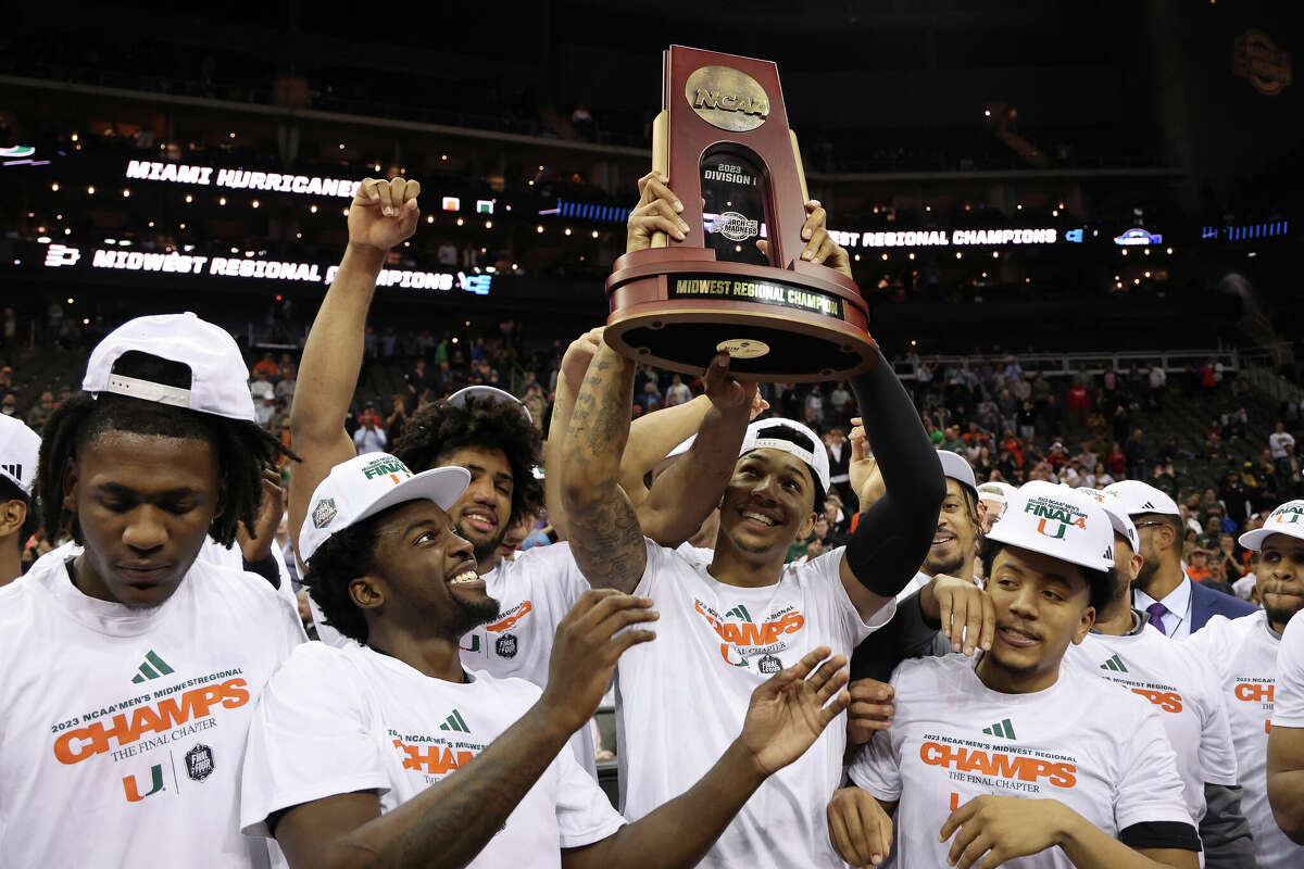 The Miami Hurricanes hoist the trophy after defeating the Texas Longhorns 88-81 in the Elite Eight round of the NCAA Men's Basketball Tournament at T-Mobile Center on March 26, 2023 in Kansas City, Missouri.