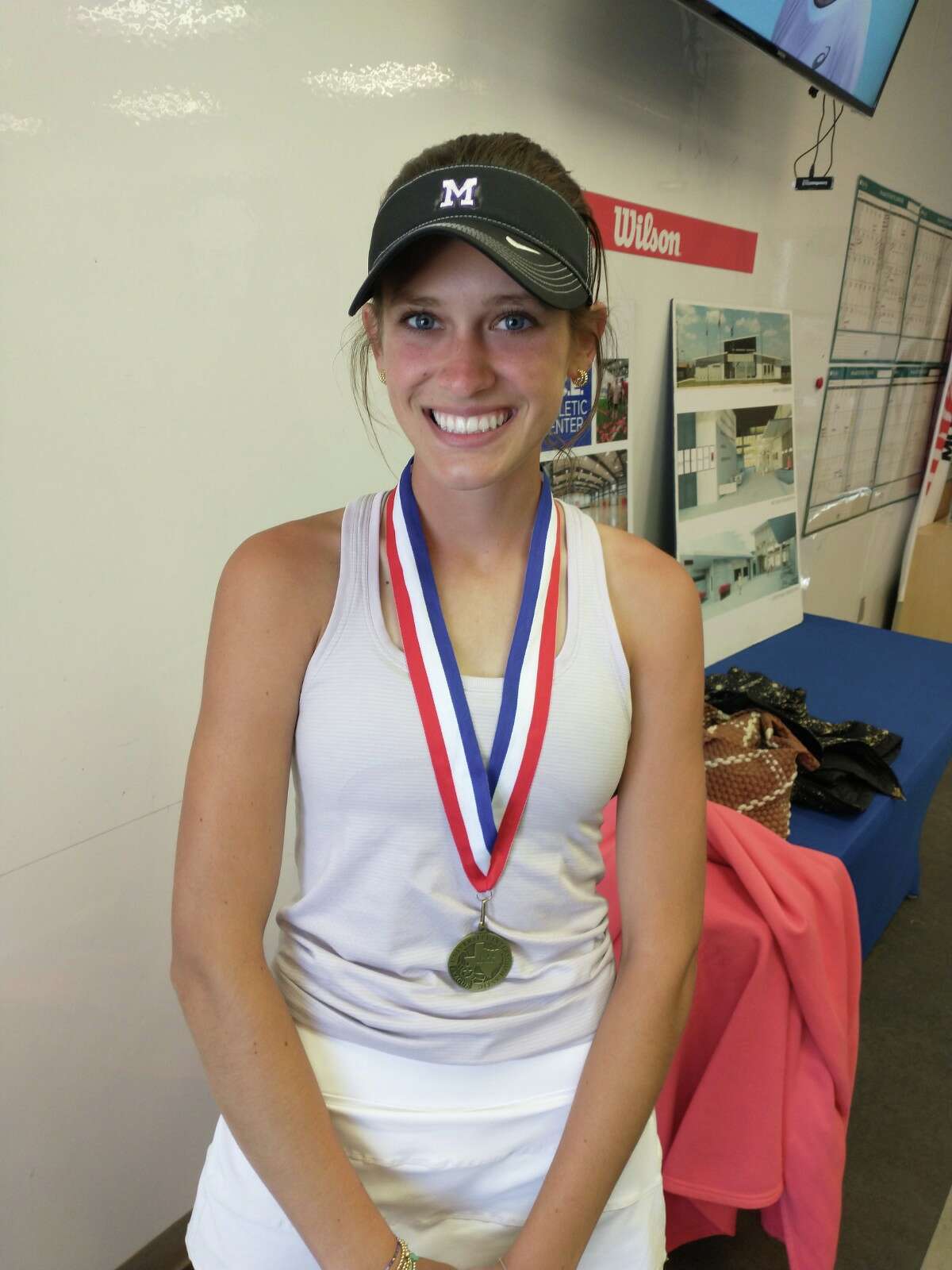 Midland High senior Sarah Stewart poses after winning the District 2-6A girls singles title on 3/31/2023 at the Bush Tennis Center. 