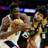 HOUSTON, TEXAS - APRIL 01: Adama Sanogo #21 of the Connecticut Huskies and Norchad Omier #15 of the Miami Hurricanes battle for the ball during the second half during the NCAA Men's Basketball Tournament Final Four semifinal game at NRG Stadium on April 01, 2023 in Houston, Texas. 