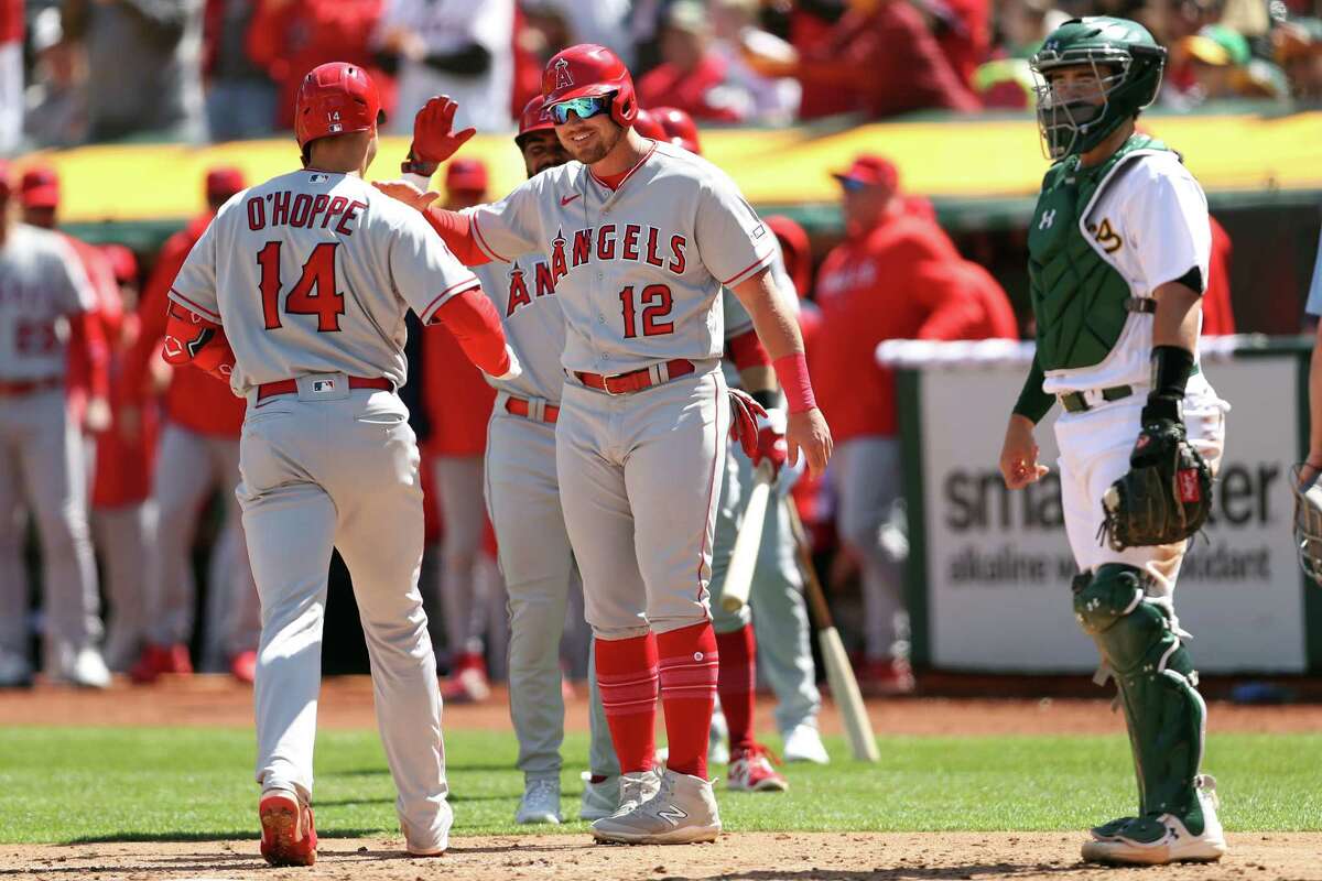 Los Angeles Angels' Hunter Renfroe (12) is greeted by Mike Trout