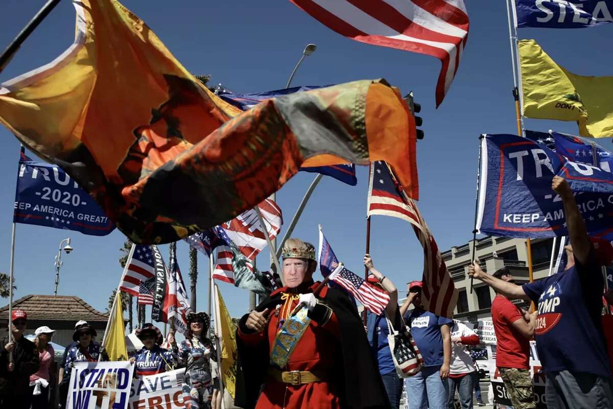 Demonstrators attend a rally in support of former President Donald Trump on Saturday, April 1, 2023, in Huntington Beach, California.