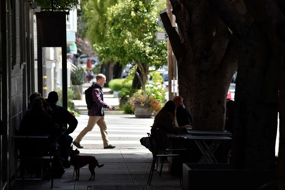 Customers sit outside along Waller Street at Cafe Reveille in the Lower Haight, on Thursday, March 30, 2023.