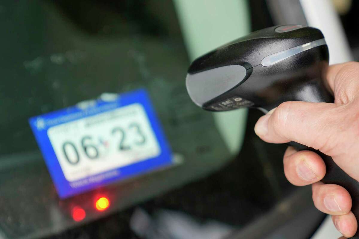 David Lowery, service manager, scans a bar code during a vehicle annual inspection at Christian Brothers Automotive, 7937 Westheimer Road, on Tuesday, April 4, 2023, in Houston.
