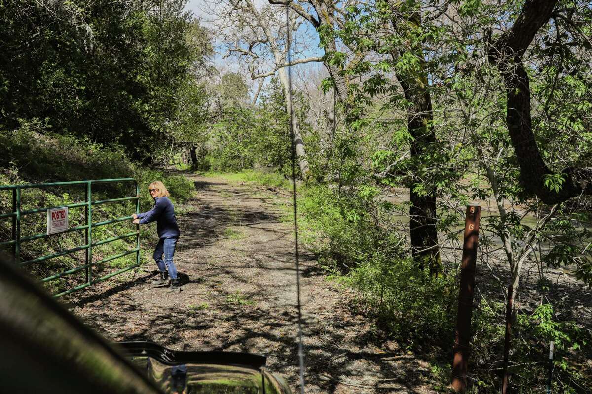 Marti Tedesco, chief marketing officer for the Peninsula Open Space Trust, closes a gate at Lakeside Ranch near Morgan Hill on Friday. “Coyote Valley has been a battleground for 60 years in terms of development,” said Tedesco. “Luckily, this area hasn’t been developed.”