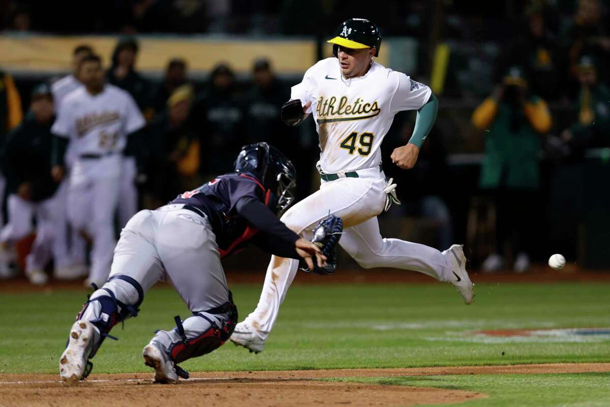 Oakland Athletics shortstop Aledmys Diaz (12) throws to first as Cleveland  Guardians' Steven Kwan (38) slides into second on a double play hit into by  Jose Ramirez during the third inning of