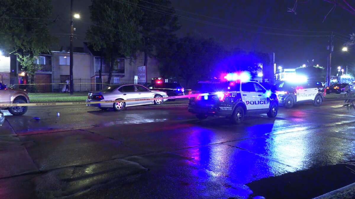 Police cars block traffic near the site of a fatal shooting in northwest Houston.