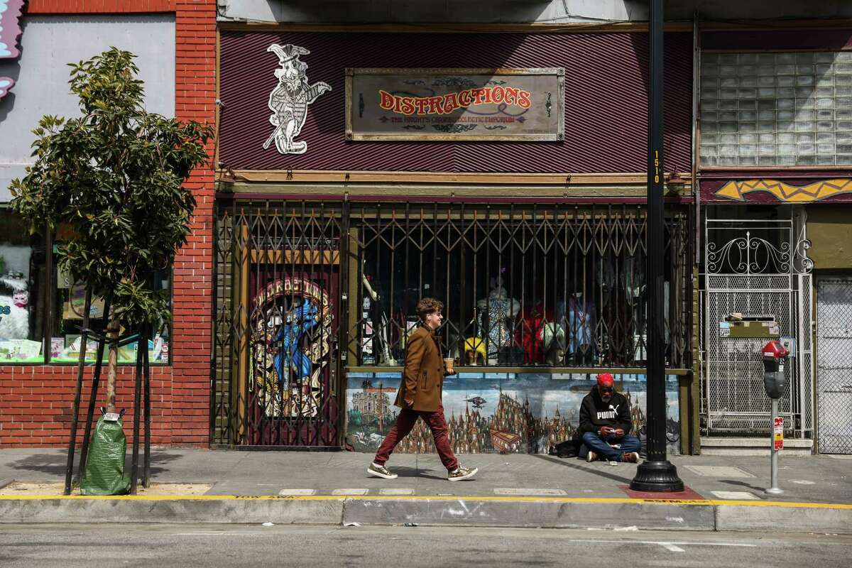 People pass by Distractions store in the Haight in San Francisco. The clothing shop has been open since 1976, but could close this fall if a buyer isn't found. Owner Jim Siegel says he's seen less business since the pandemic began.