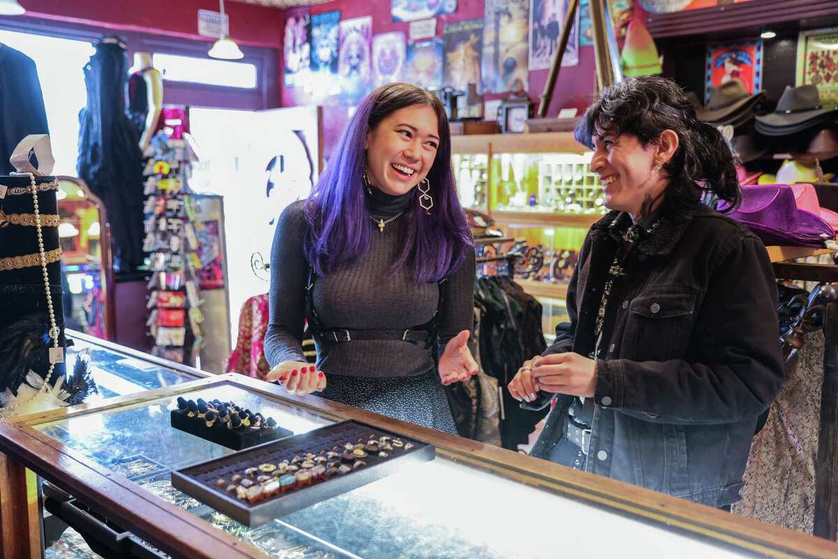 Customers Taylor Preminger and Luna Cuevas laugh as they shop at Distractions store in the Haight in San Francisco. The store is known for selling clothing to Burning Man attendees.