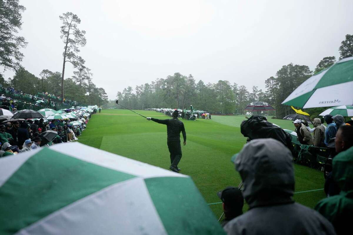 Tiger Woods point in the direction of his tee shot on the 14th hole during the weather delayed third round of the Masters golf tournament at Augusta National Golf Club on Saturday, April 8, 2023, in Augusta, Ga.