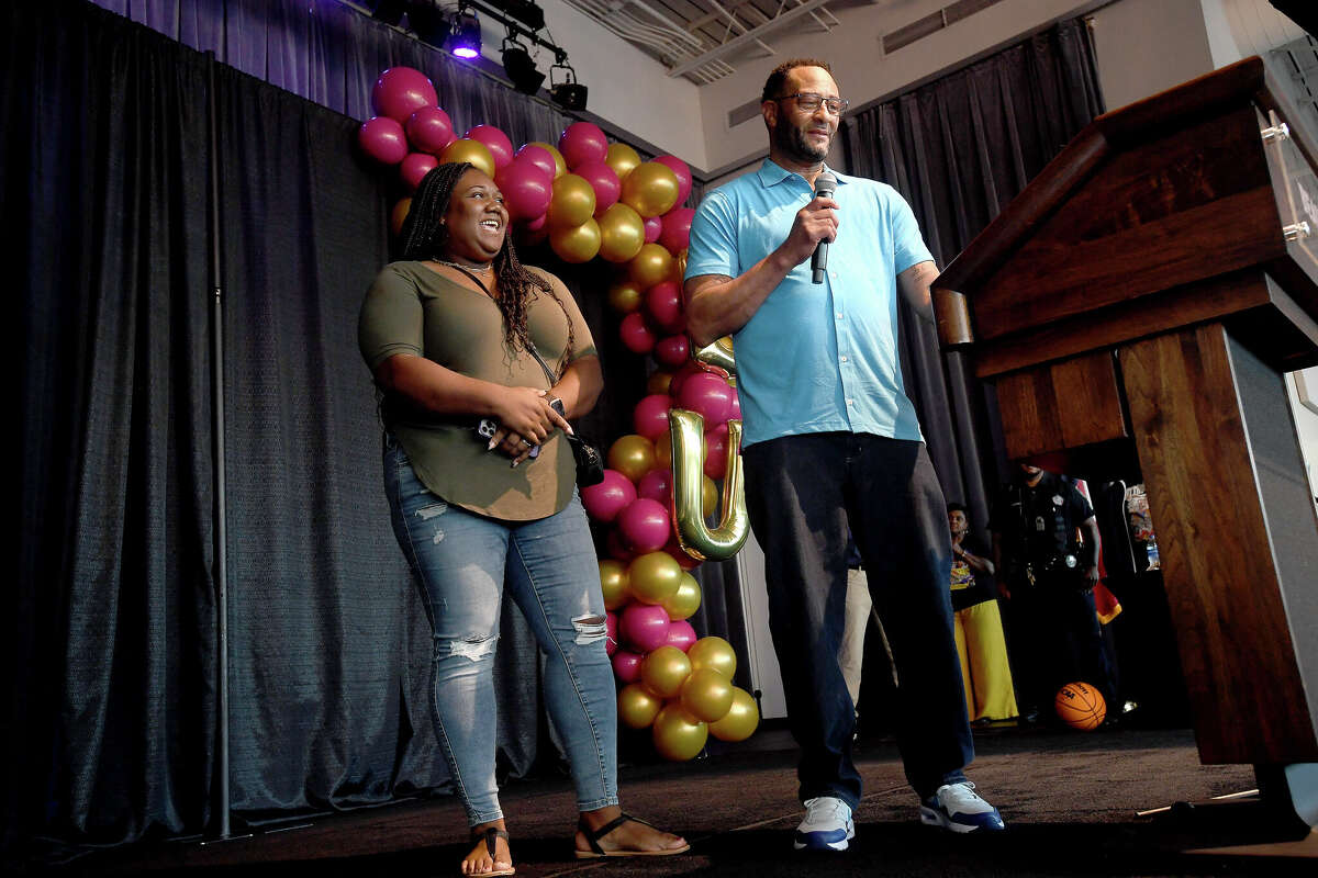 Raymond Morris talks about his daughter as her cousin Dr. Amira Davis looks on during a community celebration of hometown basketball stars Alexis Morris and the Beaumont United Timberwolves. Photo made Saturday, April 8, 2023 Kim Brent/Beaumont Enterprise