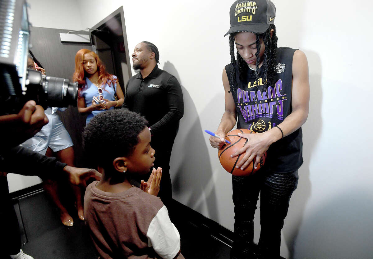 Alexis Morris signs a ball for a fan after arriving for a community celebration of hometown basketball stars Alexis Morris and the Beaumont United Timberwolves. Photo made Saturday, April 8, 2023 Kim Brent/Beaumont Enterprise