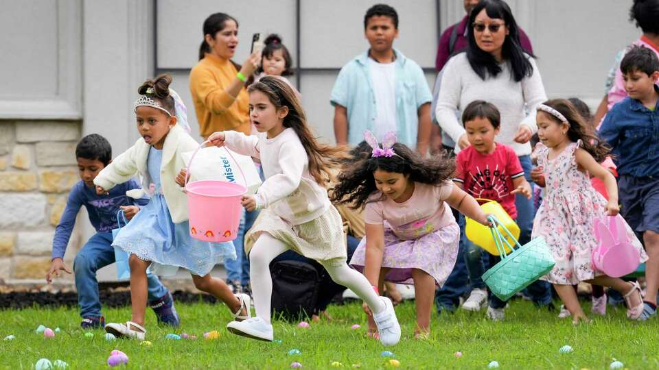 Kids scramble for treat-filled eggs during an Easter egg hunt at Church of Champions on Sunday, April 9, 2023 in Houston. The church's ChampKids made more than 3,000 eggs for kids to hunt during the event.