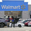 FILE - A Walmart employee helps a customer outside the Walmart store in Philadelphia, Wednesday, Nov. 17, 2021. Walmart reported stronger sales for the fiscal first quarter, Tuesday, May 17, 2022, but its profits took a beating as the nationâs largest retailer grappled with surging inflation on food and fuel and higher costs from a still snarled global supply chain. (AP Photo/Matt Rourke, File)