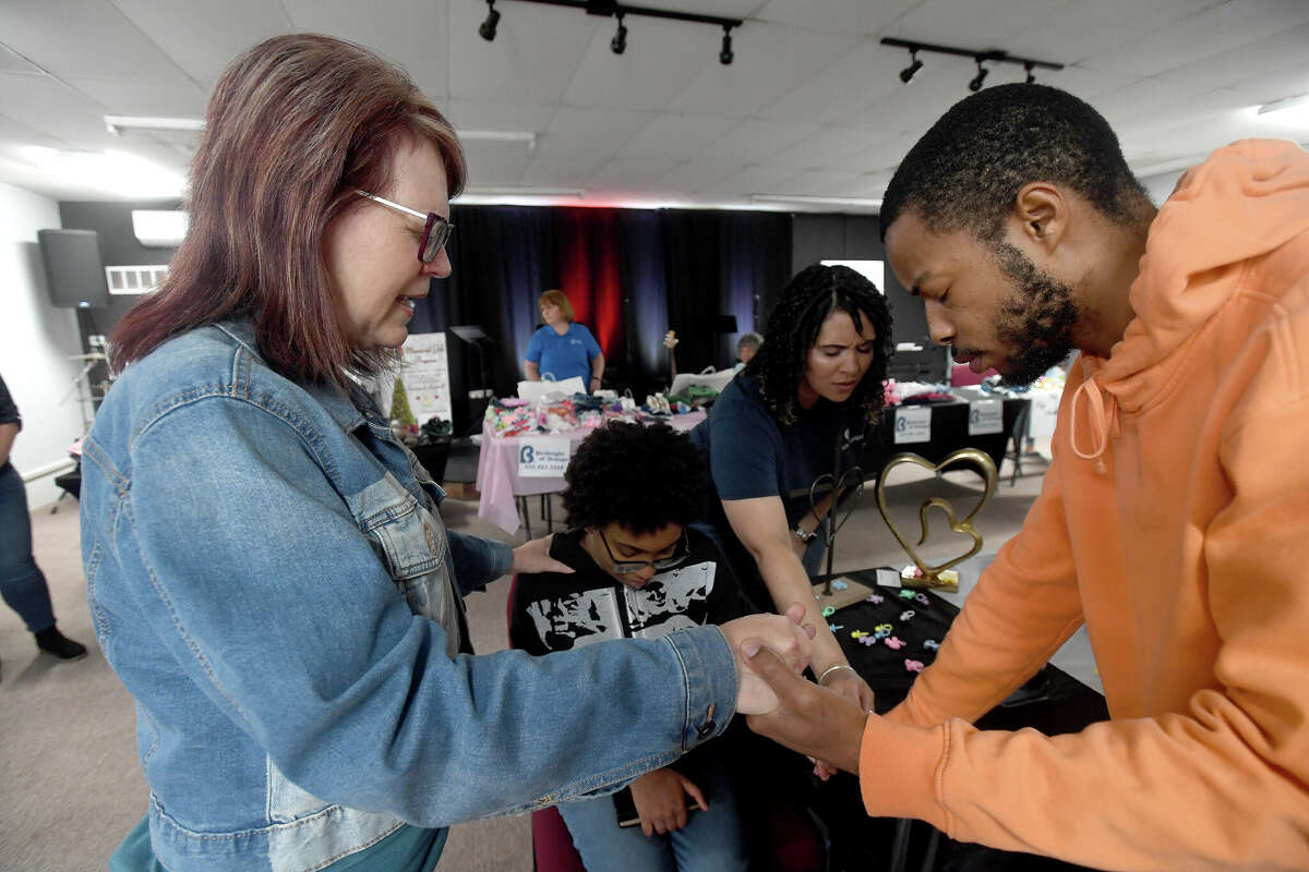 Donna Wells (left) and Tiffany Buckley with Wells of Agape, pray over expectant parents Apryl Young and Keith Vallair during the 2nd Annual Orange County Community Baby Shower at Destiny Church in Orange. Photo made Saturday, April 8, 2023 Kim Brent/Beaumont Enterprise