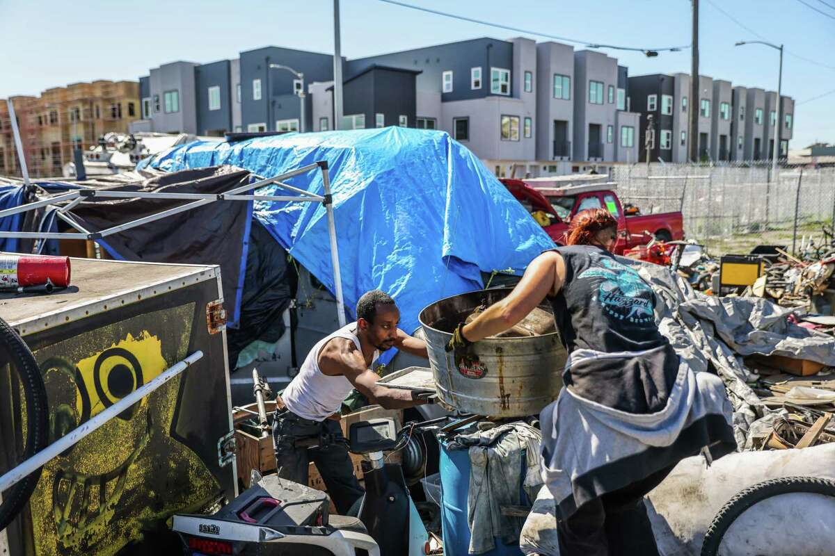 Wood Street encampment resident King David Mesfin and a neighbor Juliet move his belongings during the encampment closure on Monday.