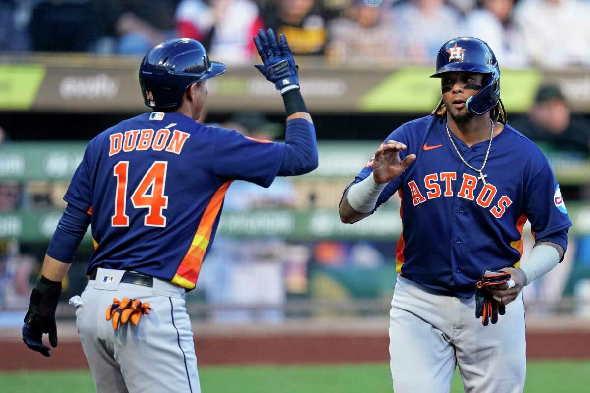Houston Astros' Martin Maldonado, right, and Mauricio Dubon, left, celebrate after they scored on a single by Astros' Yordan Alvarez off Pittsburgh Pirates starting pitcher Roansy Contreras during the second inning of a baseball game in Pittsburgh, Monday, April 10, 2023.