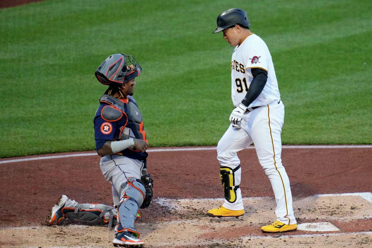 Pittsburgh Pirates' Ji Man Choi, right, steps on home plate after hitting a solo home run off Houston Astros starting pitcher Framber Valdez (not shown) during the second inning of a baseball game in Pittsburgh, Monday, April 10, 2023.