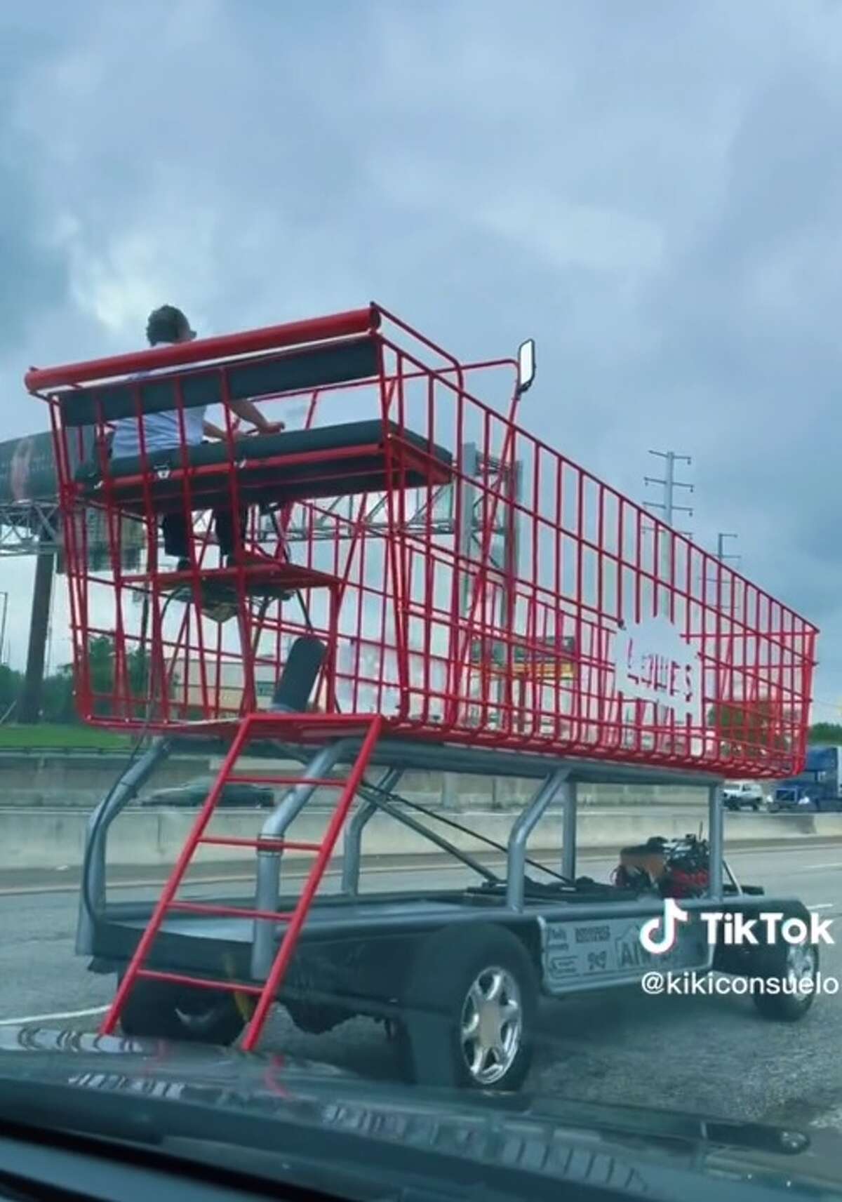 An oversized and motorized shopping cart is seen driving on San Antonio's Loop 410 in this screen capture from a TikTok video.