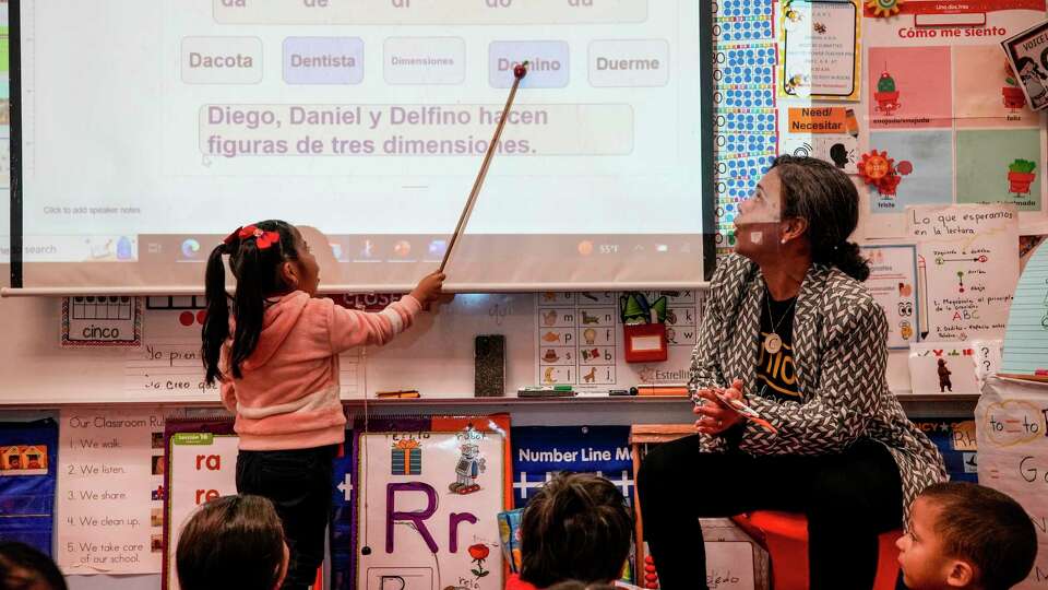 Pre-K bilingual teacher Claudia Hite works with her students at Highland Heights Elementary on Tuesday, April 11, 2023 in Houston.