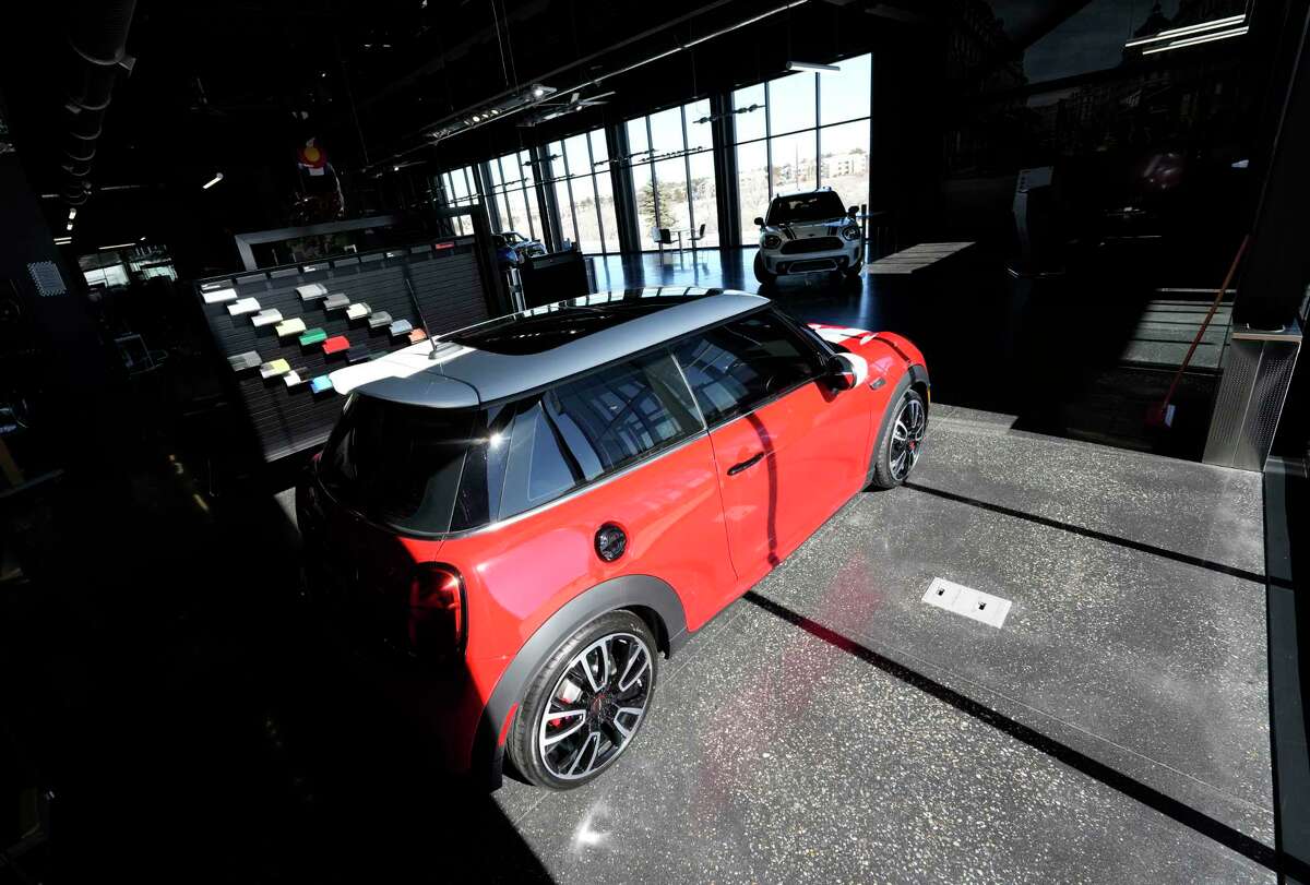 File - A 2023 Cooper S John Cooper Works hardtop sits in the light as sun streams into a Mini dealership Friday, Feb. 17, 2023, in Highlands Ranch, Colo. On Wednesday, the Labor Department reports on U.S. consumer prices for March.