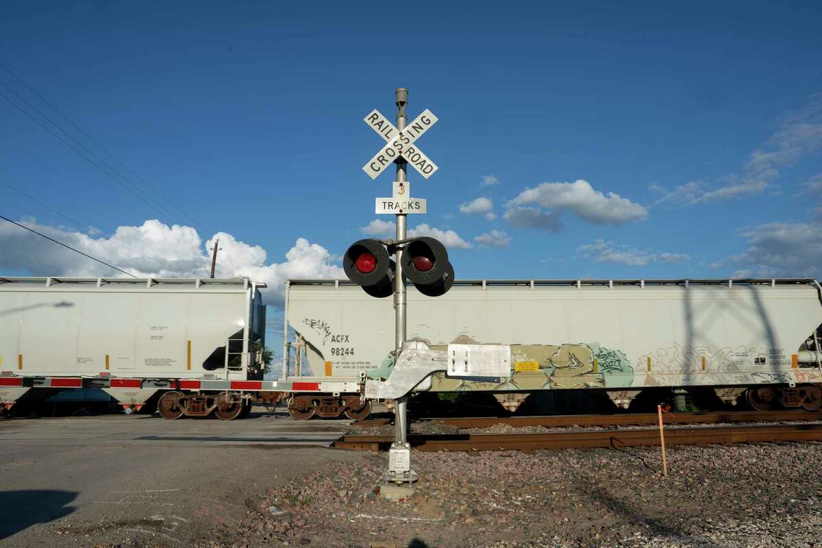 A train crosses over Lyons Road Road near Azteca Farmers Market in Houston, TX on Tuesday April 11, 2023.