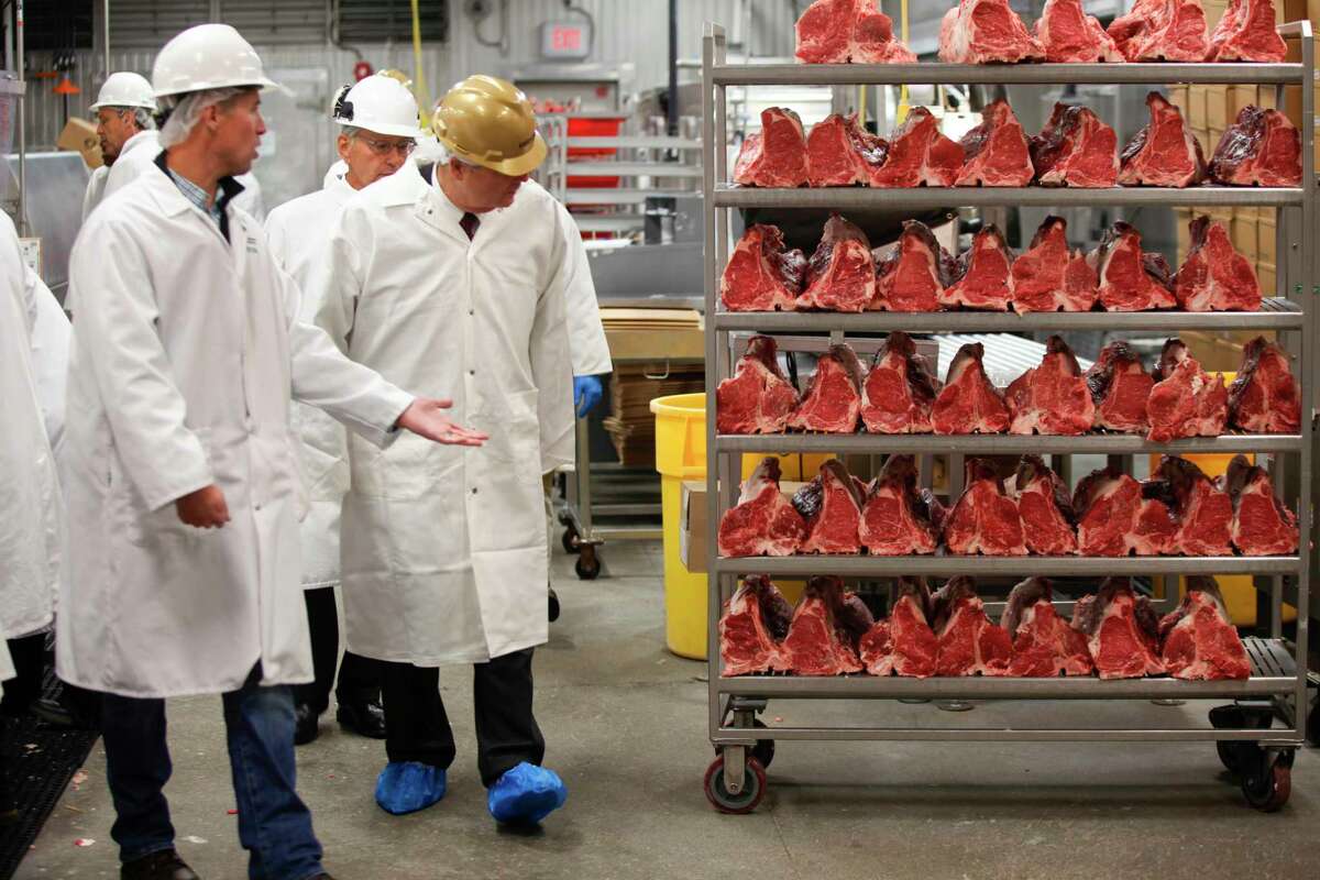 FILE - U.S. Agriculture Secretary Tom Vilsack, center, tours the Greater Omaha Packing beef processing plant in Omaha, Neb., on Nov. 2, 2022. Vilsack sent a letter Wednesday, April 12, 2023, to the 18 largest meat and poultry producers urging them to examine the hiring practices at their companies and suppliers. The letter is part of a broader effort by the Biden administration to crack down on the use of child labor.