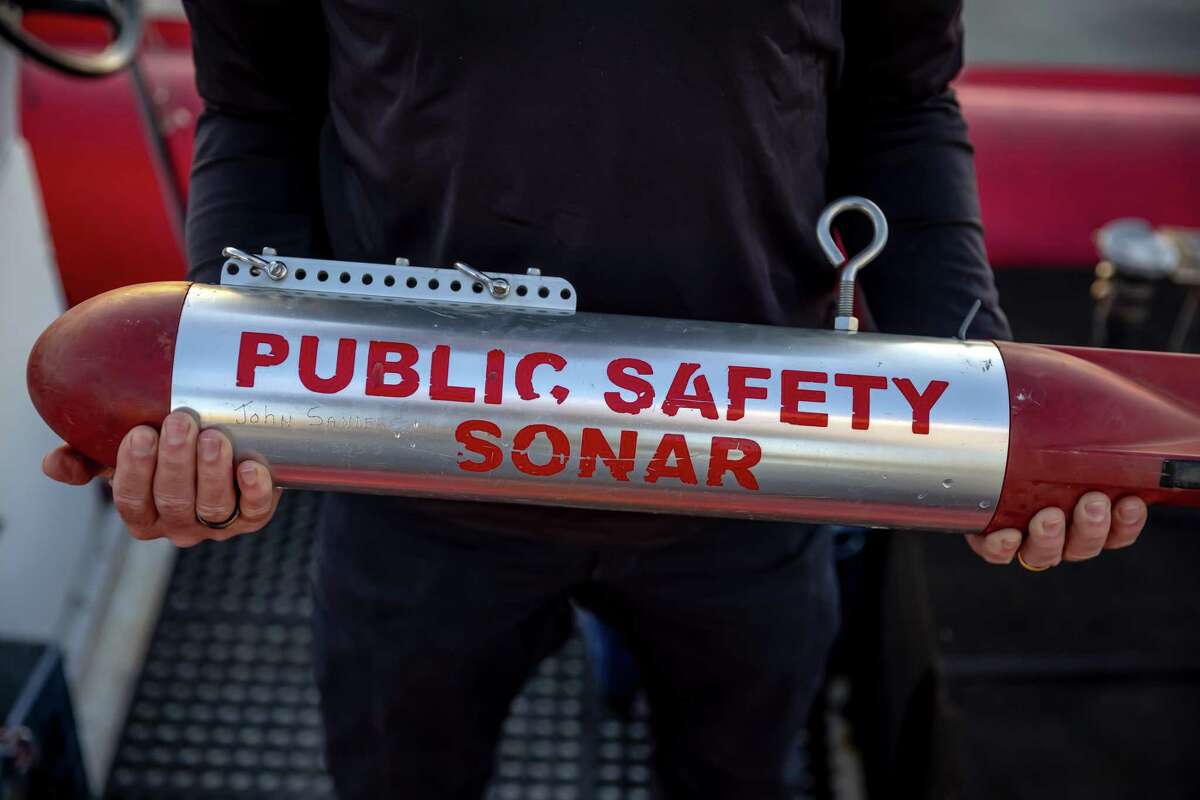 David McMurdie holds the side scan sonar towfish device on the California Recovery Divers boat in the Brooklyn Basin off Alameda.  The team is a group of trained volunteers who search for and recover missing persons in the waters of Northern California.