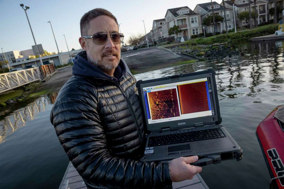 California Recovery Divers team member Kevin Haugh holds scan data taken in the Brooklyn Basin off Alameda.  The team is a group of trained volunteers who search for and recover missing persons in the waters of Northern California.