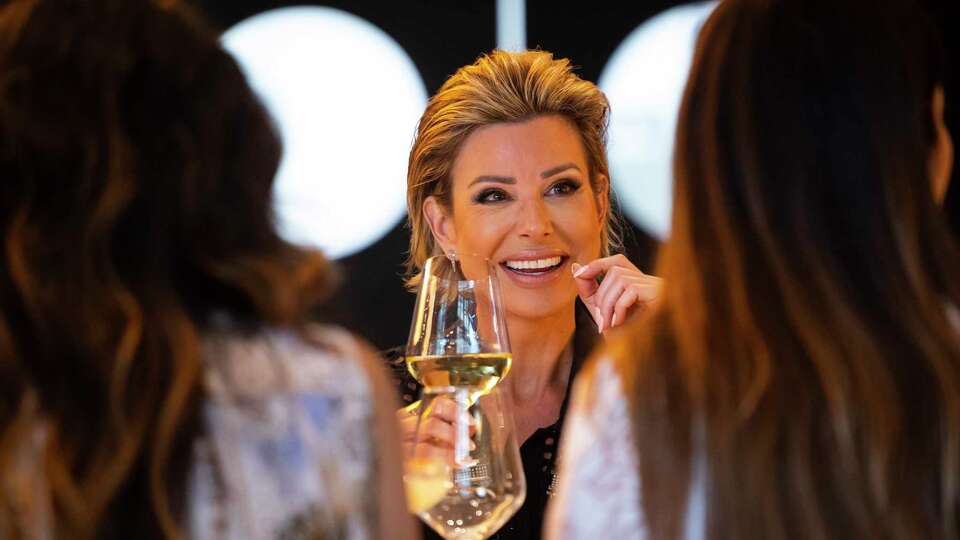 Dominique Sachse chats with people during a dinner hosted by designer Christy Lynn at Bari in the River Oaks District on Thursday, April 13, 2023.