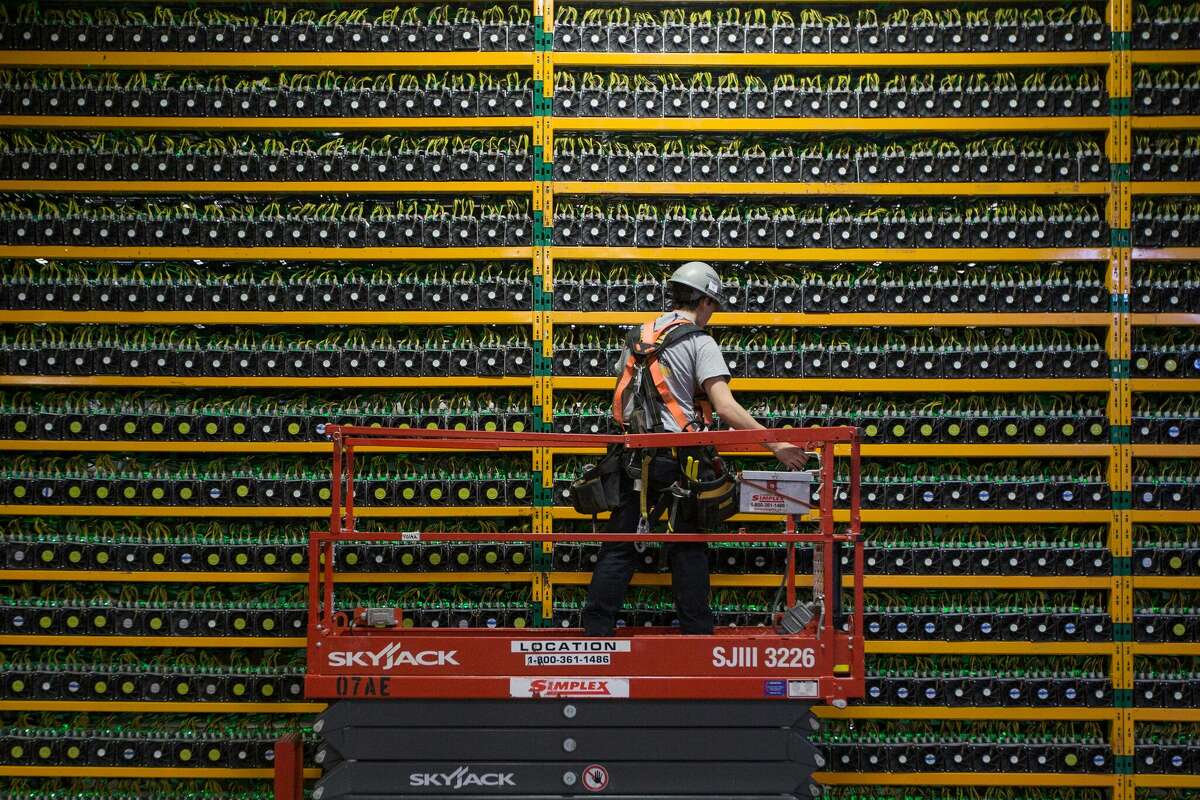   A technician inspects the back end of bitcoin mining at Bitfarms in Saint Hyacinthe, Quebec.  Despite its growing popularity, local and regional banks have chosen to steer clear of cryptocurrency due to the medium's high volatility and associated risks.  (Photo: Lars Hagberg/Getty Images)