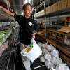 Southeast Texas Food Bank worker Xavier Bertrand helps bag up non-perishables inside their mobile pantry during the Food Giveaway at Harvest for Lost Souls Church in South Park Thursday. Photo made Thursday, April 13, 2023 Kim Brent/Beaumont Enterprise