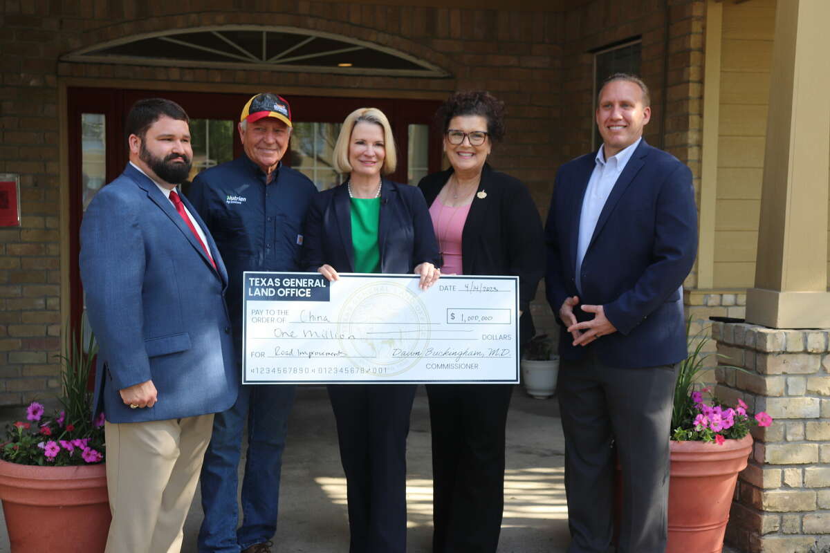 A China resident, representatives of state officials and Texas Land Commissioner Dawn Buckingham pose for a photo on April 14, 2023 at Sunlight Manor Apartments in Beaumont.