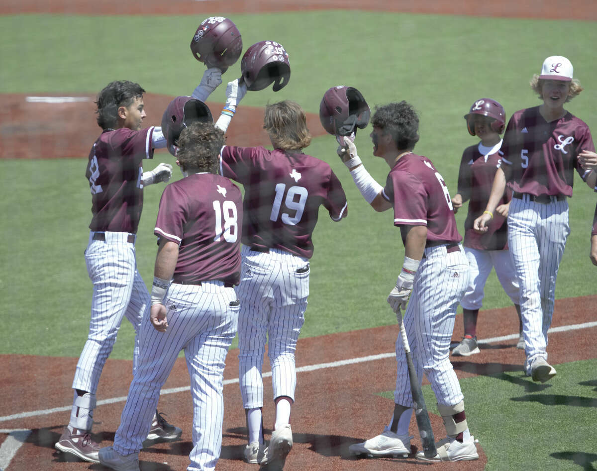 Legacy's Trajan Chavez, far left, taps helmets with Casen Yonts (18), Cole Neatherlin (19) and Aiden Serrano (6) after hitting a grand slam against San Angelo Central, April 15 at Ernie Johnson Field. 