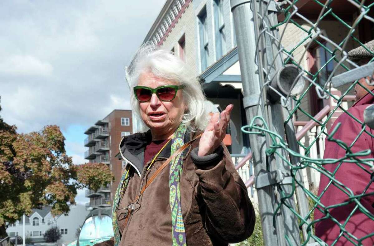 Renee Kahn, artist and architectural historian, stands in front of row houses on Franklin Street as she speaks about the chain link fences that surround buildings in downtown Stamford during a tour of historic downtown Stamford on Saturday, Oct. 16, 2010.