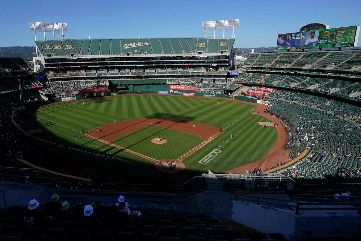 FILE - People watch a baseball game at Oakland Coliseum between the Oakland Athletics and the Texas Rangers in Oakland, Calif., July 23, 2022. The Athletics have signed a binding agreement to purchase land for a new retractable roof stadium in Las Vegas after being unable to build a new venue in the Bay Area. Team president Dave Kaval said Wednesday, April 19, 2023, that the team finalized the deal to buy the 49-acre site last week close to the Las Vegas Strip.