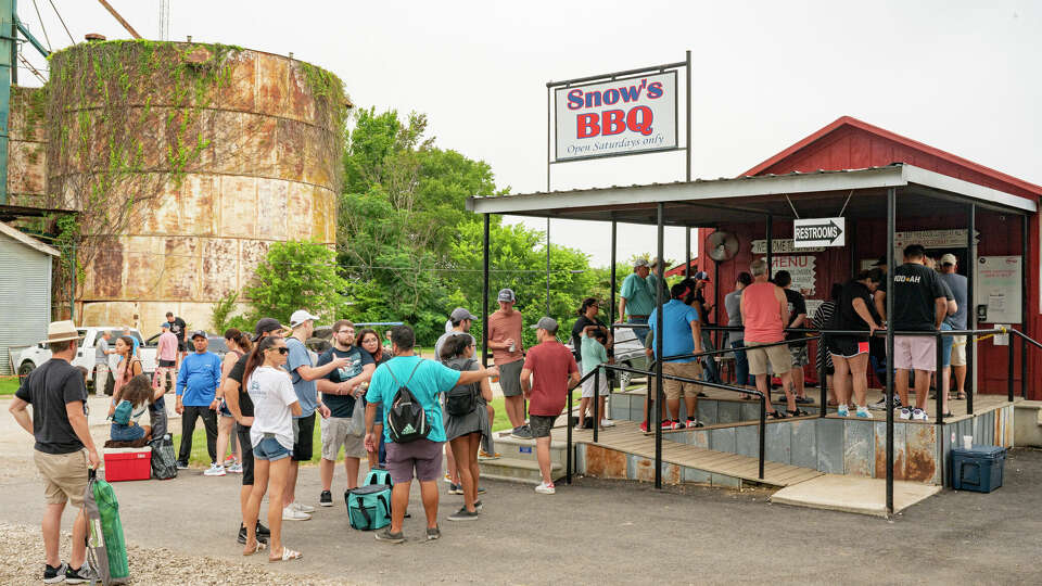 LEXINGTON, TEXAS - JULY 31: Patrons stand in line outside Snow's BBQ on July 31, 2021 in Lexington, Texas. (Photo by Jim Bennett/Getty Images)