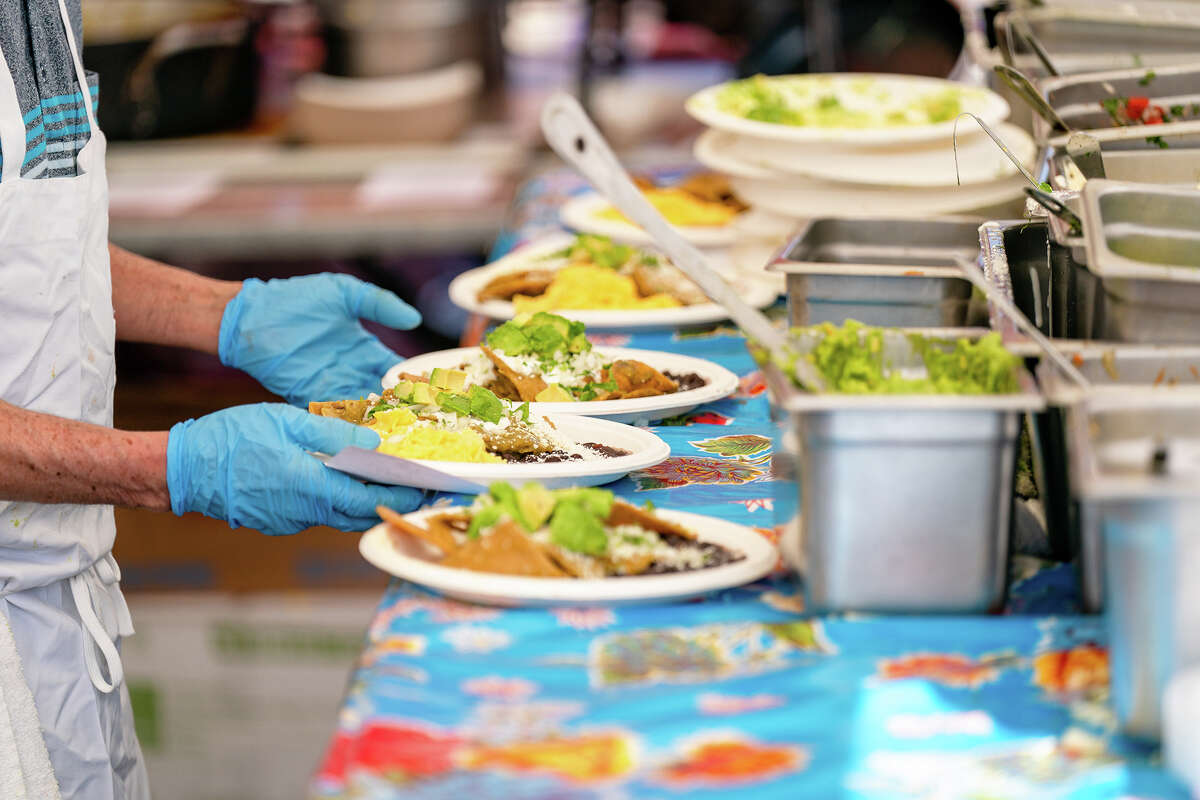 Multiple orders of chilaquiles are prepared at the Primavera stall at the Ferry Plaza Farmers Market on Saturday, April 15, 2023.