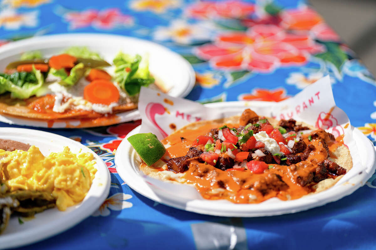 An order of Chilaquiles, a Tamale plate, and an Open Face Pork Taco Arabe Al Pastor sit ready for pickup by customers at the Primavera stall at the Ferry Building Farmer's Market on Saturday, April 15, 2023.