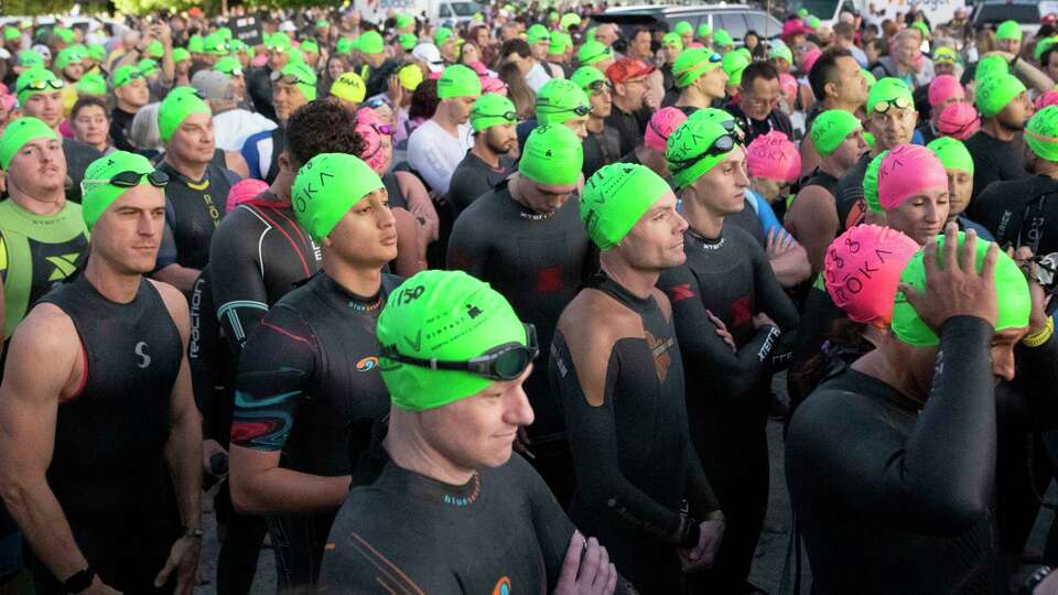 Triathletes wait to begin the swimming portion of the Texas Ironman triathlon at Northshore Park, Saturday, April 22, 2023, in The Woodlands.