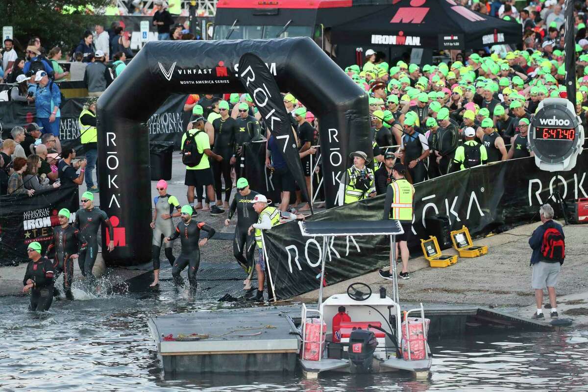 Triathletes take part in the swimming portion of the Texas Ironman triathlon, Saturday, April 22, 2023, in The Woodlands.