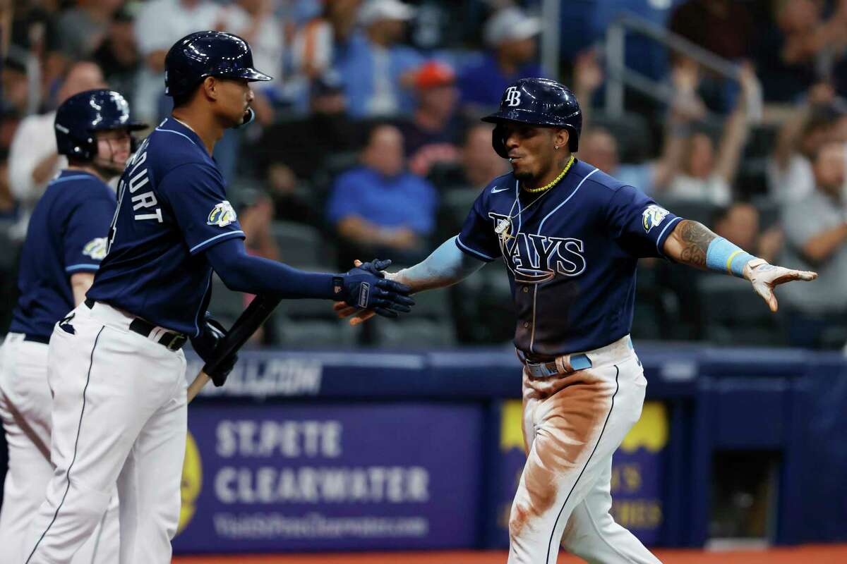 Tampa Bay Rays' Wander Franco, right, celebrates with teammate Christian Bethancourt after scoring against the Houston Astros during the third inning of a baseball game Monday, April 24, 2023, in St. Petersburg, Fla.