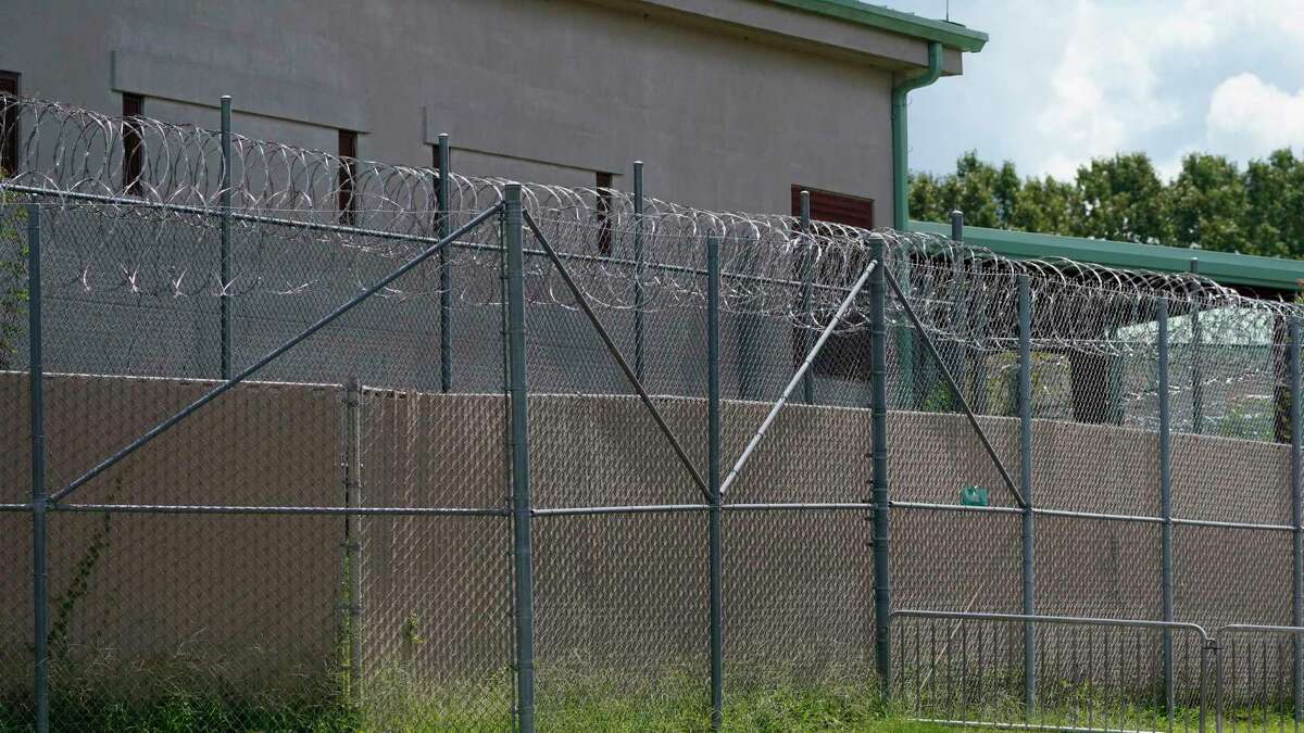 FILE - Rolls of razor wire line the top of the security fencing at the Raymond Detention Center in Raymond, Miss., on Aug. 1, 2022. Four prisoners are on the loose after escaping over the weekend from the Mississippi jail already under federal scrutiny for alleged mismanagement. In an escape that began around 8 p.m. Saturday, the four detainees broke free from the Raymond Detention Center, a facility near the state capital of Jackson, through breaches in a cell and in the roof, Hinds County Sheriff Tyree Jones said at a Monday, April 24, 2023 news conference.