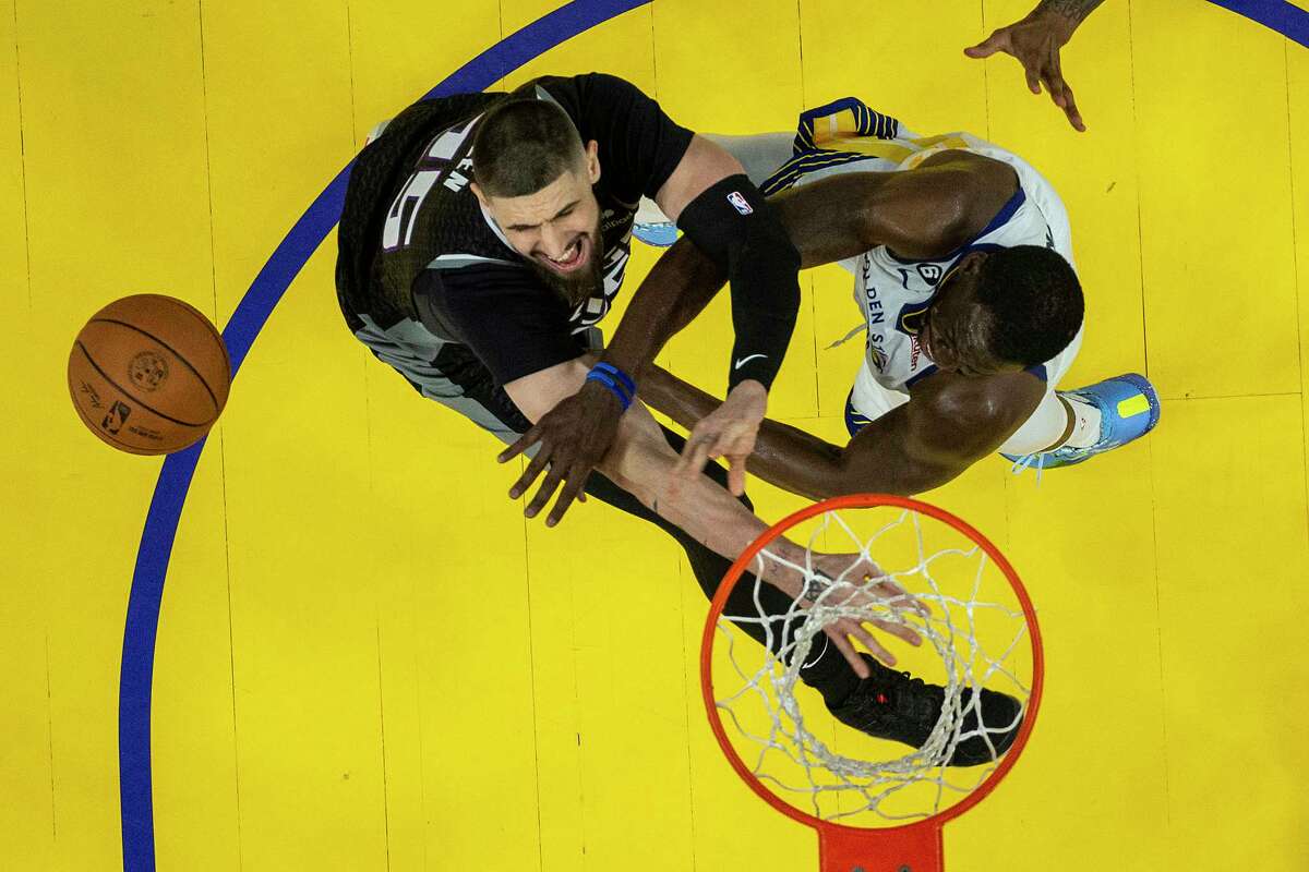 Warriors forward Draymond Green (right) and Sacramento Kings center Alex Len fight for a rebound in the second half of Game 4 at Chase Center on Sunday.