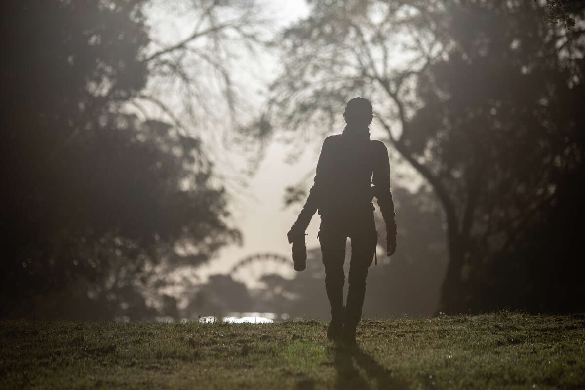 Janet Kessler walks while photographing coyotes in Golden Gate Park in San Francisco, California April 27, 2023.  Kessler has been taking pictures of the coyotes in the park for years.