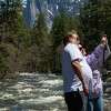 Dan and Teresa Hoffman take selfies alongside the Merced River in Yosemite National Park, Calif., on Thursday, April 27, 2023.. The couple live in Burbank, Calif., and have visited Yosemite many times.