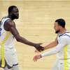 Stephen Curry (30) celebrates with Draymond Green (23) after he made a basket and was fouled late in the second half as the Golden State Warriors played the Sacramento Kings in Game 5 of the NBA Western Conference first round Playoffs at Golden 1 Center in Sacramento, Calif., on Wednesday, April 26, 2023.
