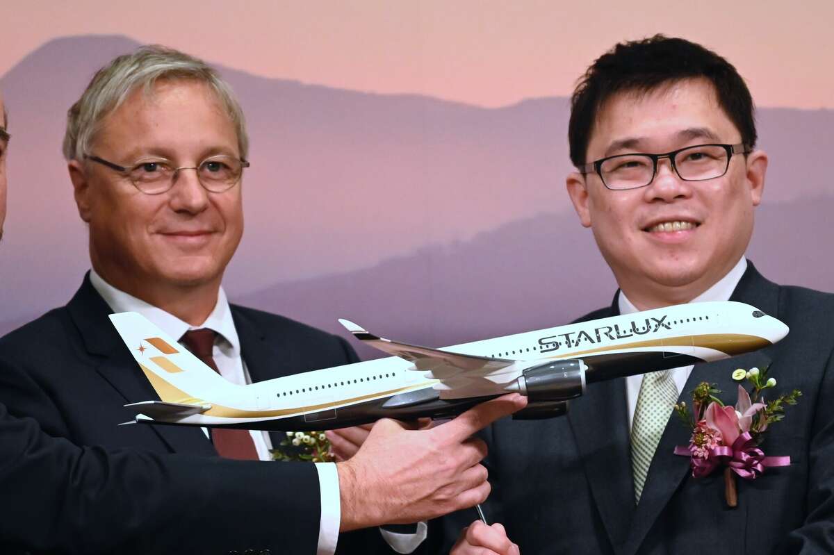 Starlux chairman Chang Kuo-wei, right, receives an Airbus 350-1000 model from Christian Scherer, chief commercial officer of Airbus, during a signing ceremony in Taipei on March 19, 2019.