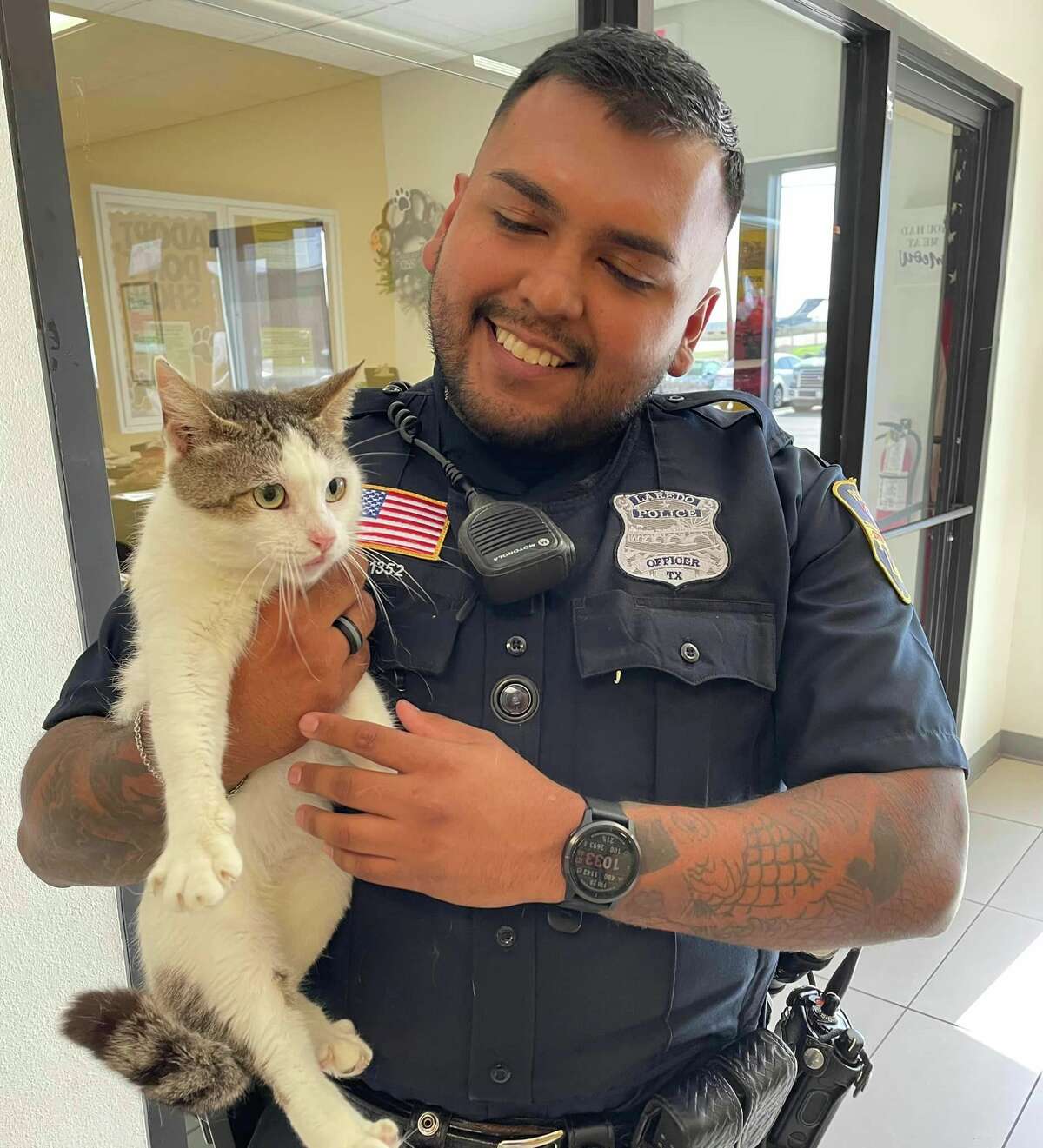 Officer C. Leal from the Laredo Police Department is pictured with Luna, a 3-year-old c cat up for adoption through Laredo Animal Care Services.