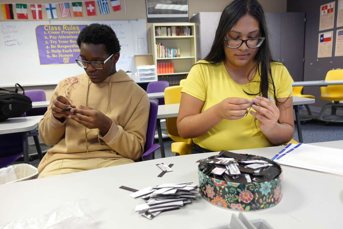 Sabine Pass juniors Alexander Jackson, left, and Lashly DeLuna, right, create magnets to use for a timeline to study for the upcoming UIL State Social Studies meet. Photo taken April 26, 2023. Photo by Olivia Malick/ The Enterprise.