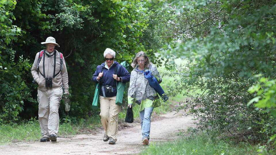 Bird watchers John Black, Judy Black and Heather Wasaff make their way through the George Mitchell Nature Preserve to take part in the Great Texas Birding Classic, Saturday, April 29, 2023, in The Woodlands. The state-wide competition, divided into 14 categories spanning from a day to a week-long, brings together birdwatchers of all skill levels. More than 1,000 watchers participate in last year's event from across the state and identified 425 species of birds.